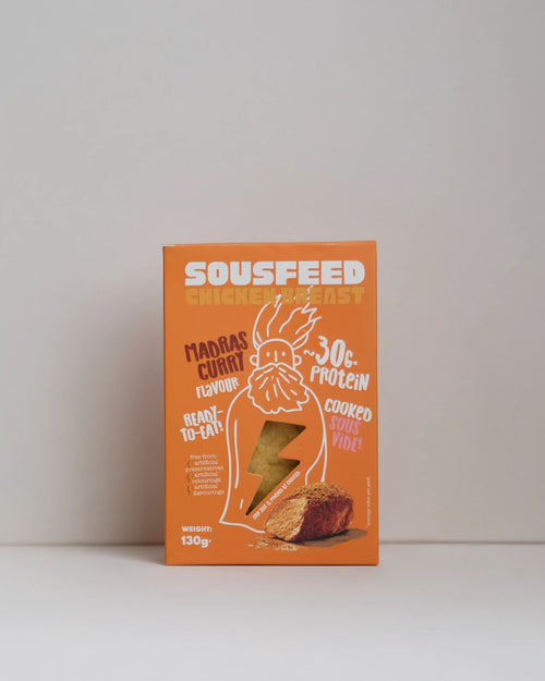 Front view of a SousFeed madras curry flavoured chicken breast and its packaging on a white background