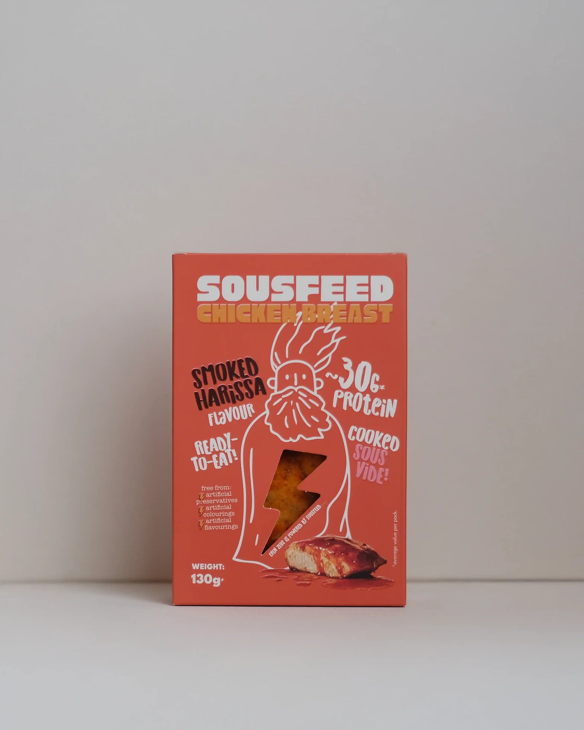 Front view of a SousFeed smoked harissa flavoured chicken breast and its red packaging on a white background