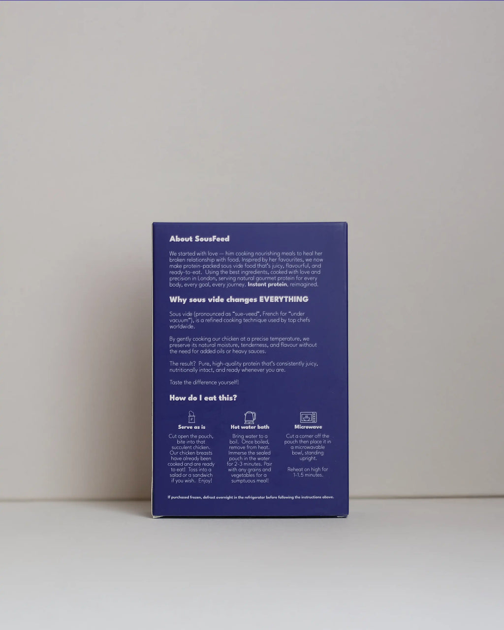 Back view of a SousFeed Salt and Pepper flavoured chicken breast and its purple packaging on a white background