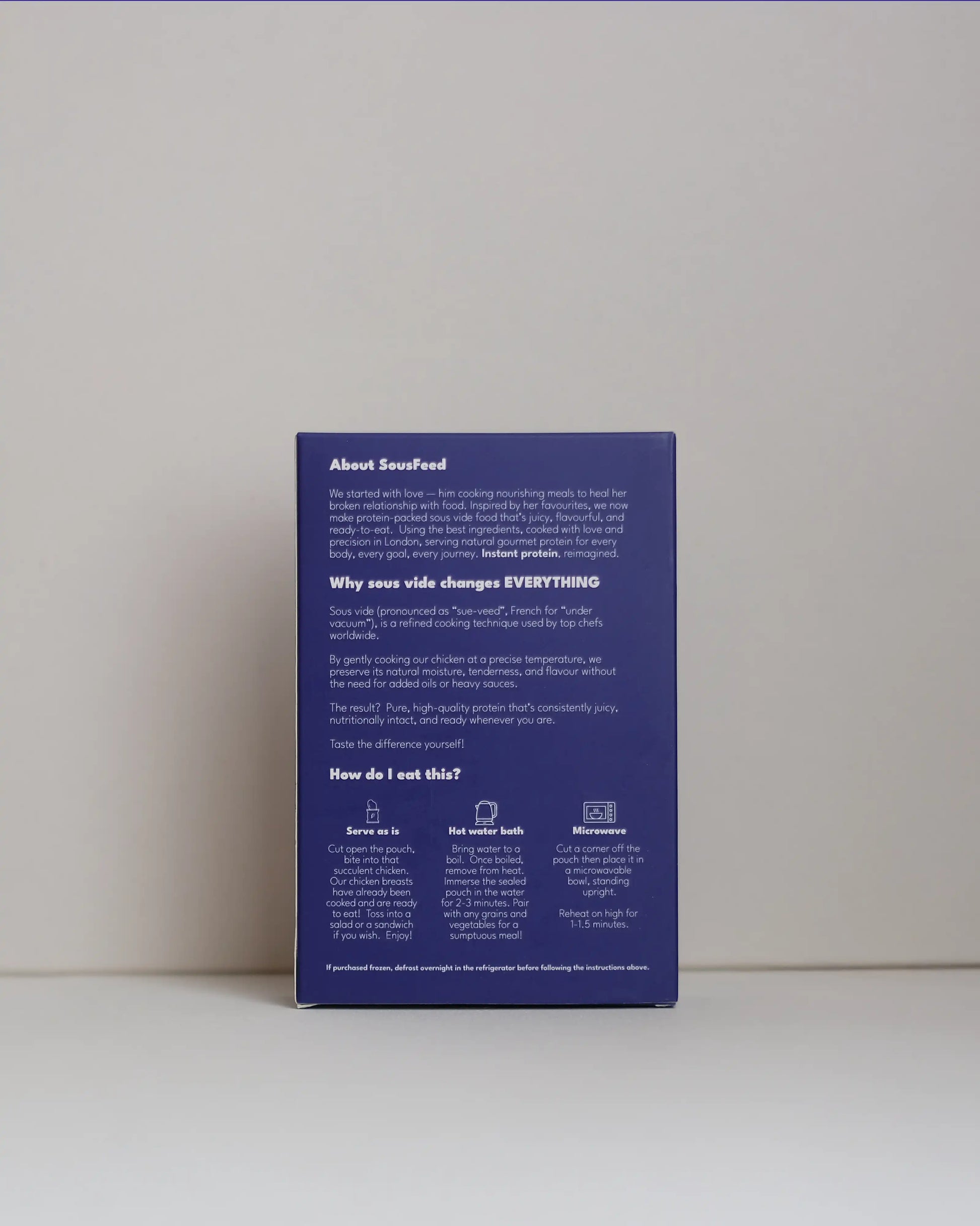 Back view of a SousFeed Salt and Pepper flavoured chicken breast and its purple packaging on a white background