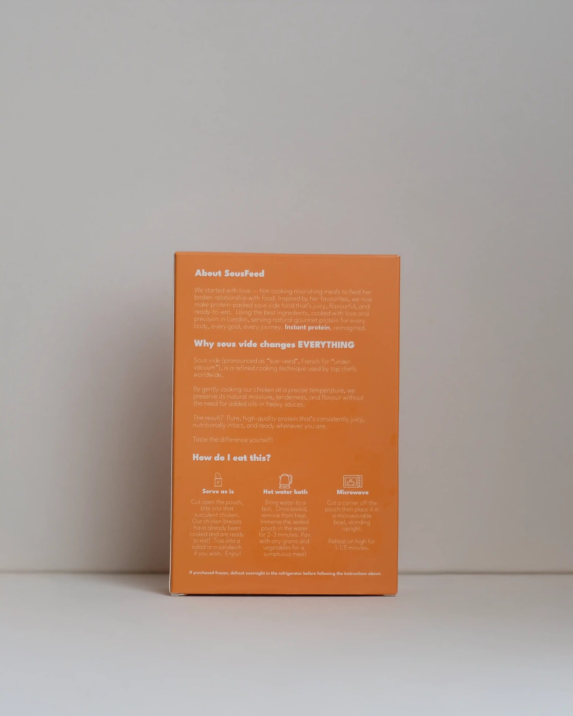 Back view of a SousFeed madras curry flavoured chicken breast and its packaging on a white background