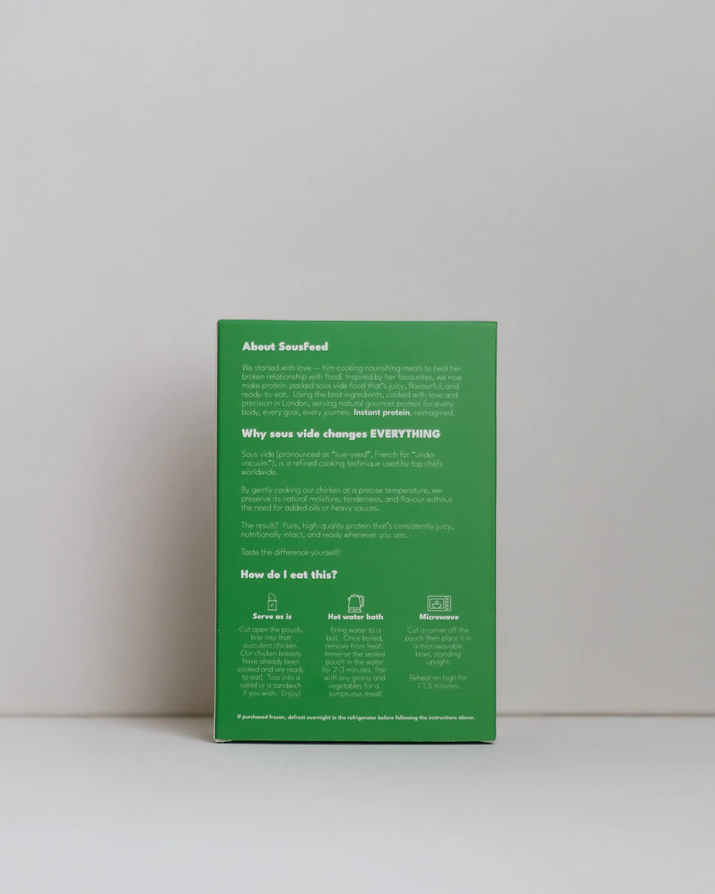 Back view of a SousFeed pesto alla genovese flavoured chicken breast and its light green packaging on a white background