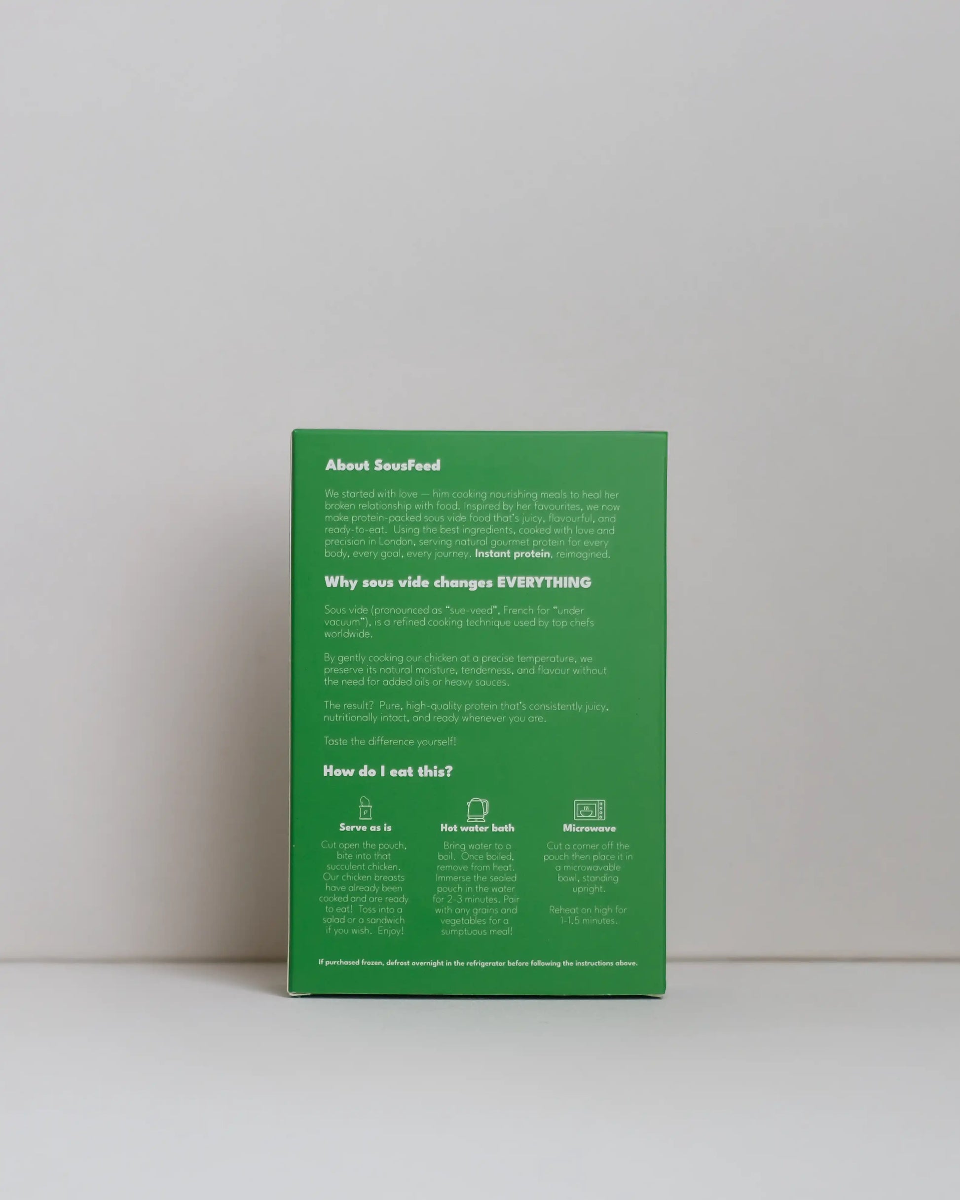 Back view of a SousFeed pesto alla genovese flavoured chicken breast and its light green packaging on a white background