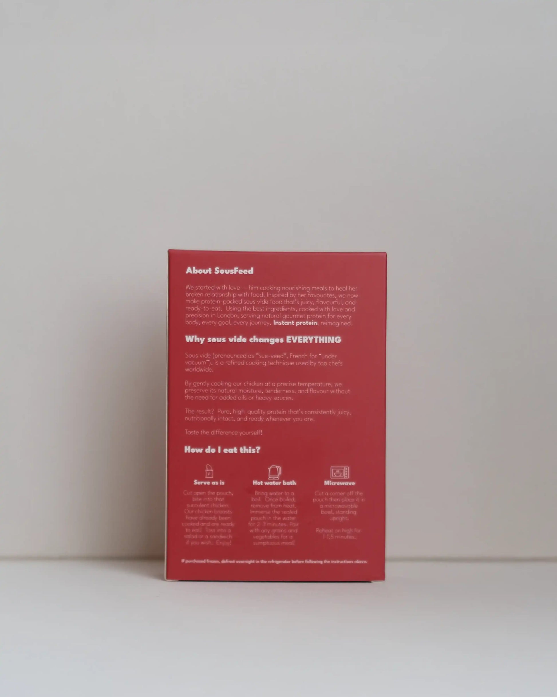 Back view of a SousFeed tomato bomb flavoured chicken breast and its packaging on a white background