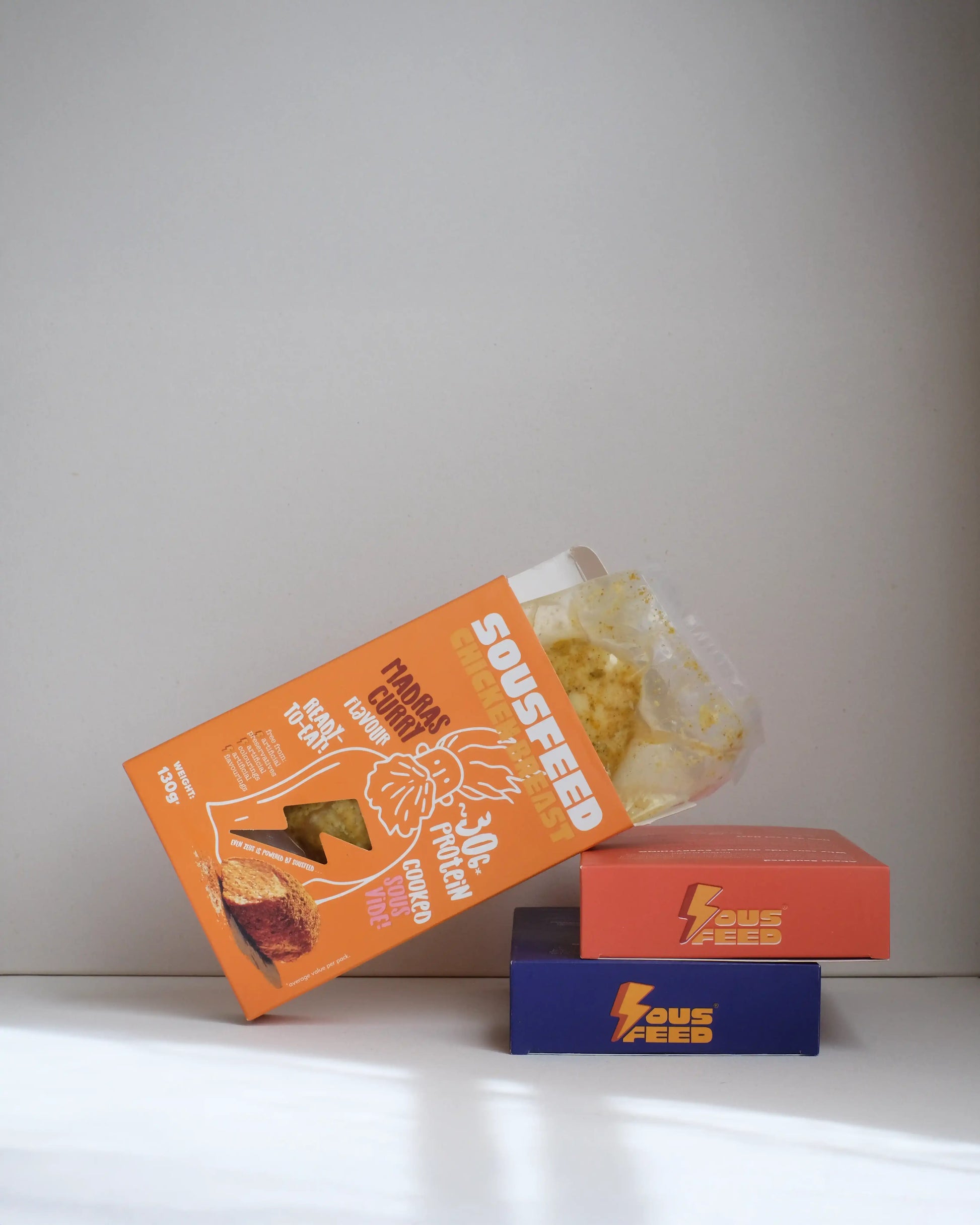 Sousfeed madras curry flavoured chicken breast with its packaging on a white background