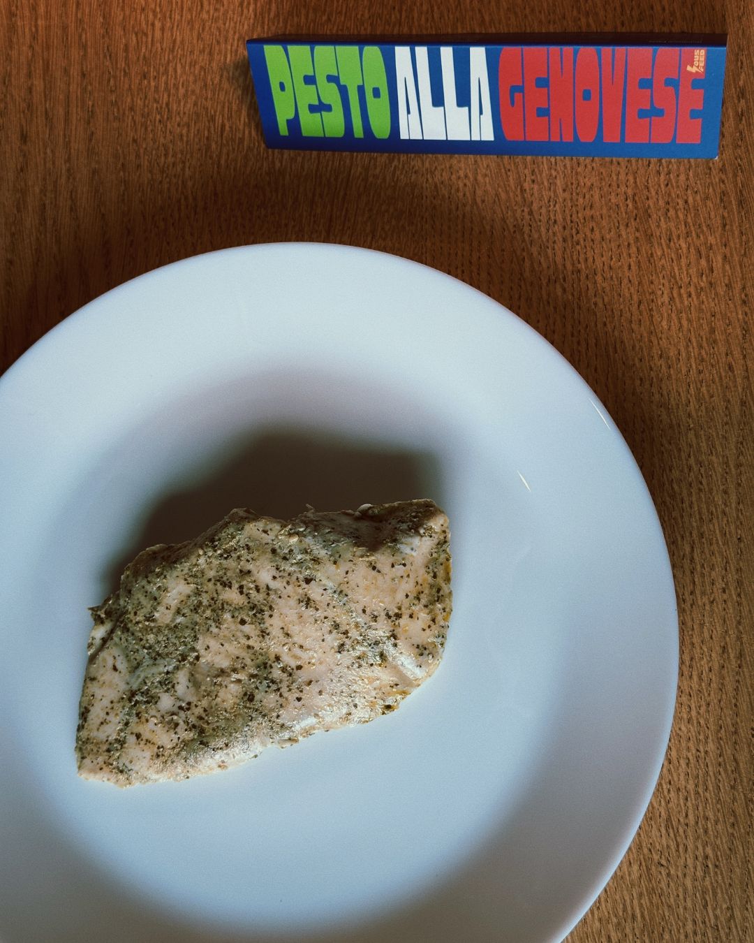 A moist SousFeed Pesto Alla Genovese chicken breast on a plate clean white plate.